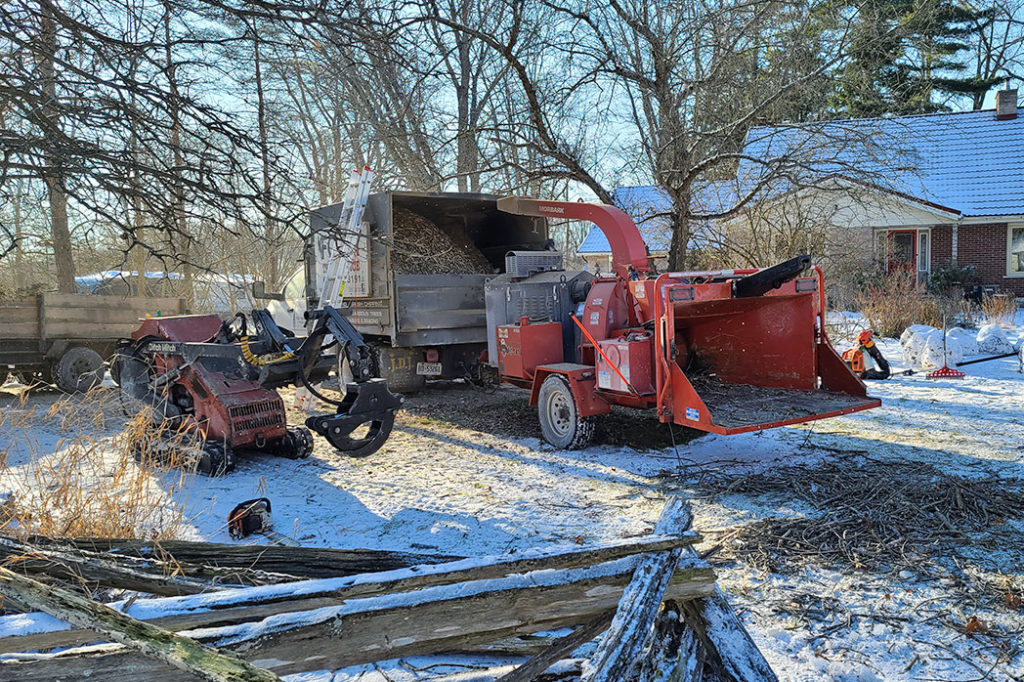 Ditch Witch equipment parked next to wood chipper