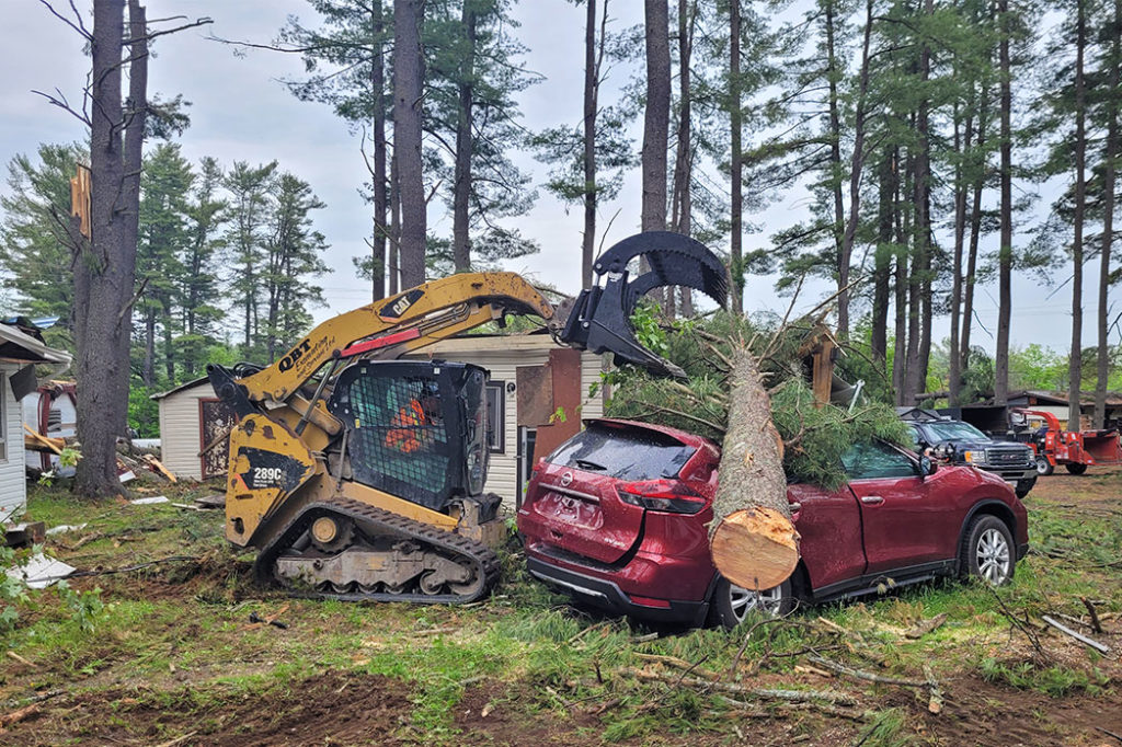 Foley Tree Service team member using equipment to remove fallen tree on SUV